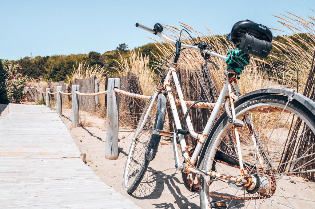A bike on the beach. Consider renting a bike if you plan a sustainable holiday.